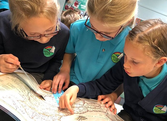 Schoolchildren looking at a map